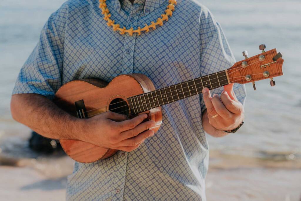 hawaii ukulele musician playing music during a vow renewal ceremony on the beach